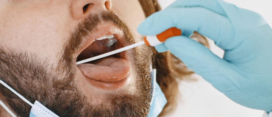 man undergoing saliva mouth swab drug test